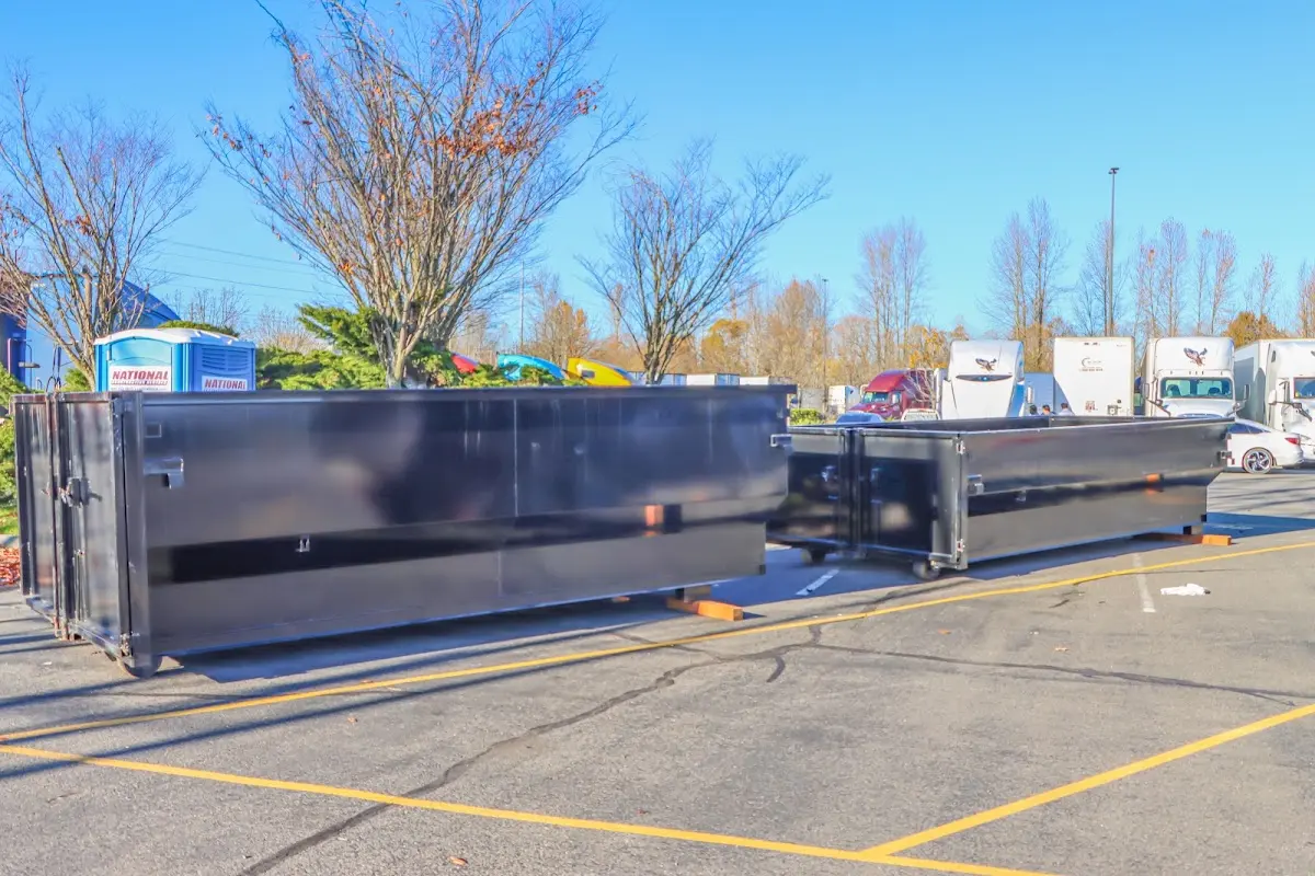 Professional dumpster rental service with roll-off container on residential driveway in Belvedere Park